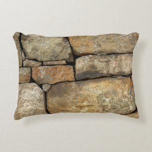 A stone wall made of cobblestones background textu accent pillow
