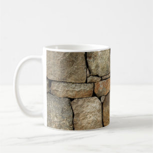 A stone wall made of cobblestones background textu coffee mug