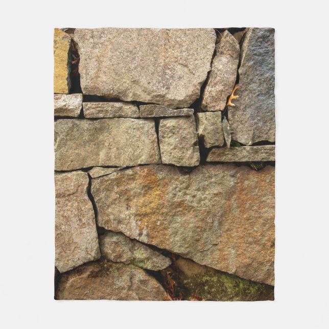 A stone wall made of cobblestones background textu fleece blanket (Front)
