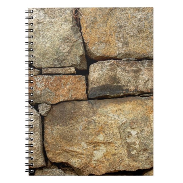 A stone wall made of cobblestones background textu notebook (Front)