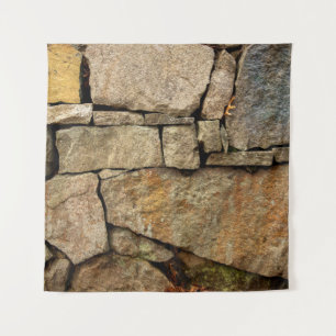 A stone wall made of cobblestones background textu tapestry