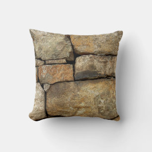 A stone wall made of cobblestones background textu throw pillow