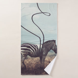 A surreal image of a zebra and two of its black st bath towel