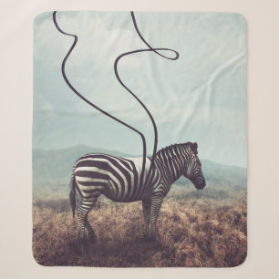 A surreal image of a zebra and two of its black st sherpa blanket