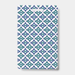 A symmetrical blue and white rug with intricate mo badge