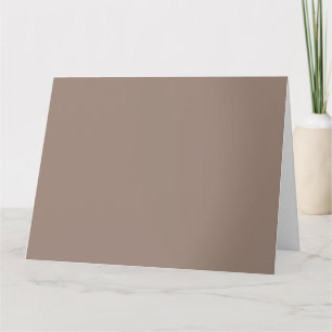 A textured background of various shades of brown,  card