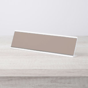 A textured background of various shades of brown,  desk name plate