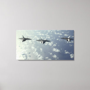 A three-ship formation of F-22 Raptors Canvas Print