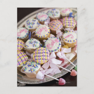 A tray of baby rattle cupcakes at a baby shower. invitation postcard