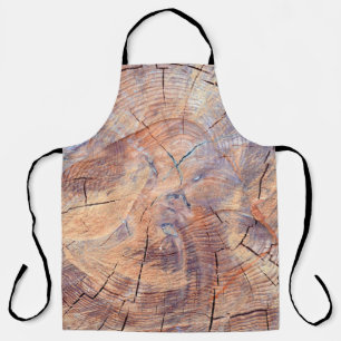 A tree in a cut. Logs lumber in the woods. Texture Apron