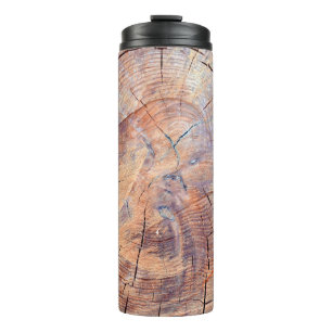 A tree in a cut. Logs lumber in the woods. Texture Thermal Tumbler