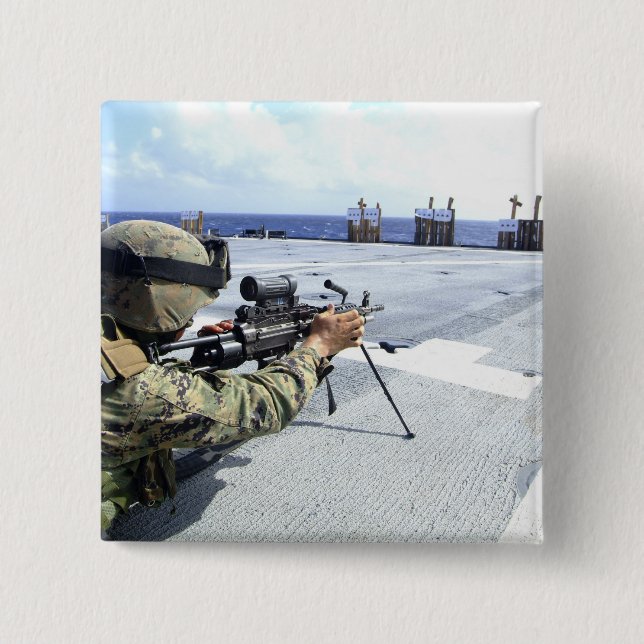 A US Marine adjusting his weapon 2 Inch Square Button (Front)