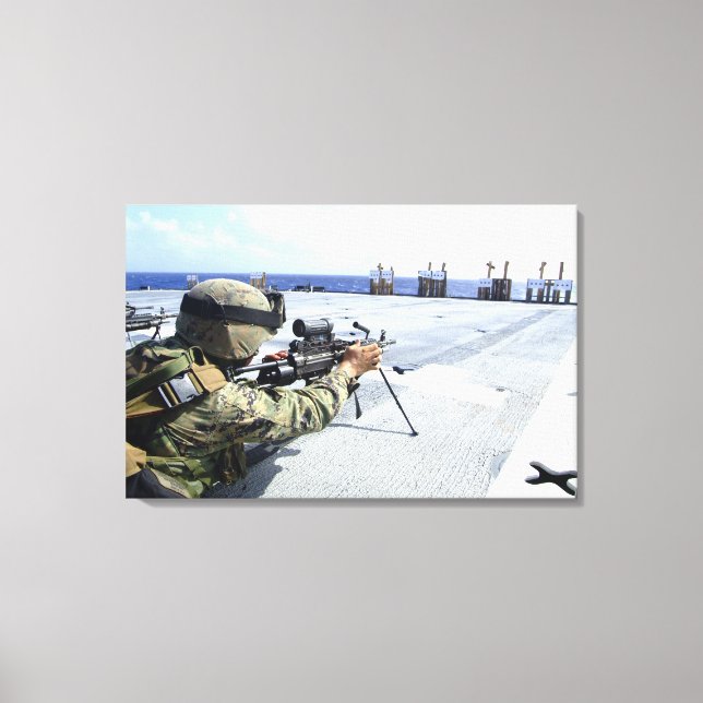 A US Marine adjusting his weapon Canvas Print (Front)