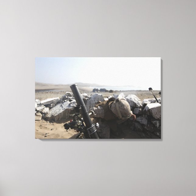 A US Marine fires a mortar in Salinas, Peru Canvas Print (Front)