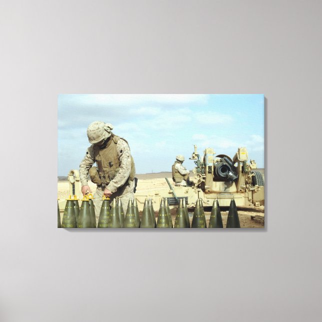 A US Marine prepares howitzer rounds to be fire Canvas Print (Front)