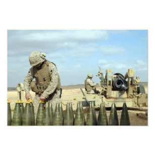 A US Marine prepares howitzer rounds to be fire Photo Print