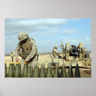A US Marine prepares howitzer rounds to be fire Poster