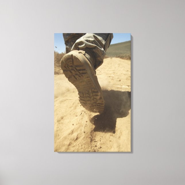 A US soldier walks along a dirt path Canvas Print (Front)
