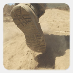 A US soldier walks along a dirt path Square Sticker