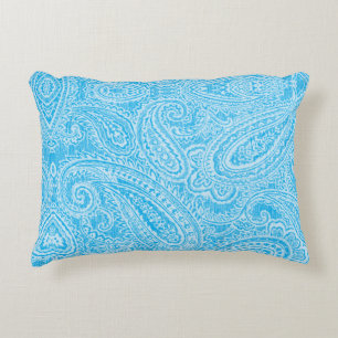 A vibrant blue fabric featuring intricate patterns accent pillow