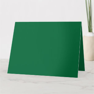 A vibrant green leaf with distinct veins is illumi card