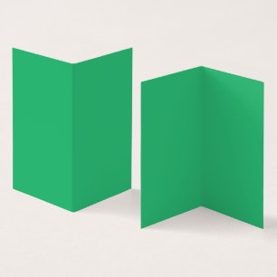 A vibrant green leaf with prominent veins and a de