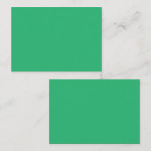A vibrant green leaf with prominent veins and a de appointment card