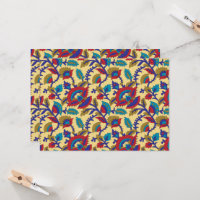 A vibrant textile art piece featuring bold red, ye