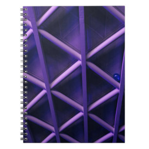 A violet ceiling with a criss-cross pattern; a blu notebook