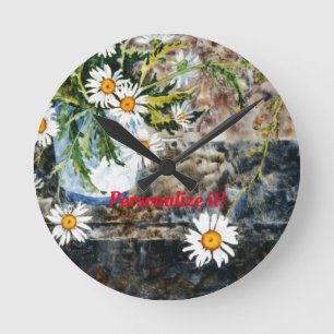 A white and blue pot of wild daisies on a shelf round clock