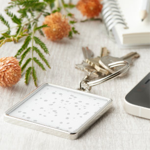 a white background with a lot of small dots keychain