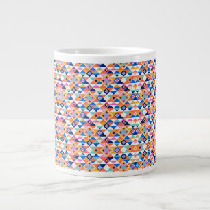 A white ceramic mug features a colorful geometric
