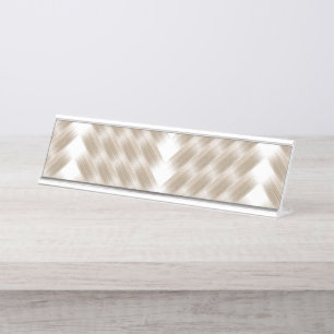 A white, equilateral triangle centred on a plain desk name plate