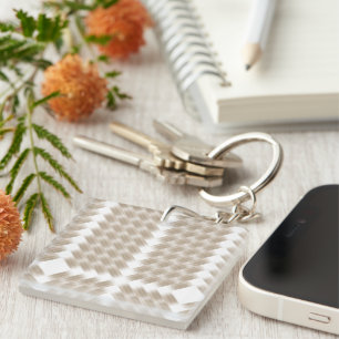 A white, equilateral triangle centred on a plain keychain