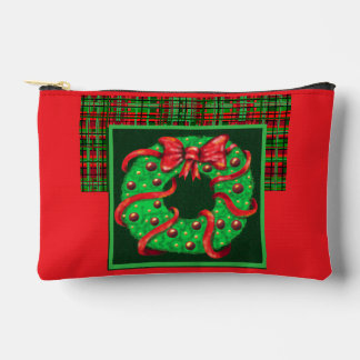 A wreath with a big red bow on plaid accessory pouch