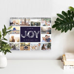 A Year of Joy | 2019 Photo Calendar<br><div class="desc">Share a favourite memory on each page of this 2019 photo calendar, with photos framed with a botanical leaves pattern in seasonal colours. Cover features a thumbnail version of each photo with "a year of joy" in the centre in white letters formed by holiday botanicals and berries. Personalize the cover...</div>