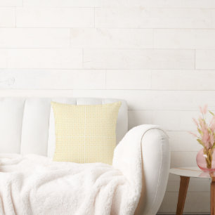 a yellow and white background with small circles throw pillow
