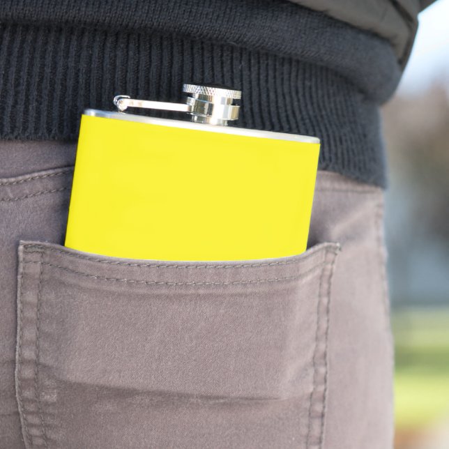 a yellow background with a black border hip flask (In Situ)