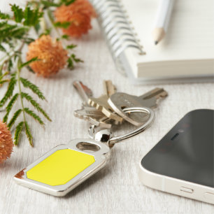 a yellow background with a black border keychain