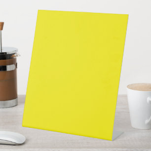 a yellow background with a black border pedestal sign