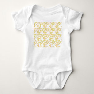 A yellow rug with a repeating motif pattern resemb baby bodysuit