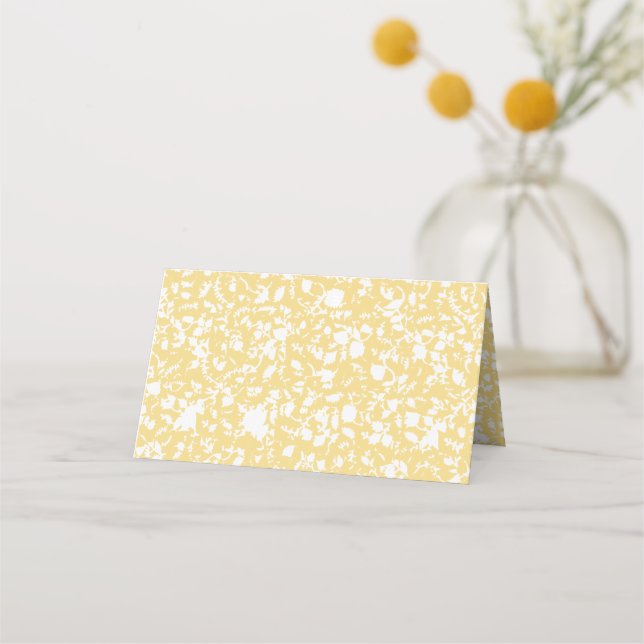 A yellow rug with a repeating motif pattern resemb place card (Front)