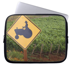 A yellow tractor crossing sign in the vineyard laptop sleeve