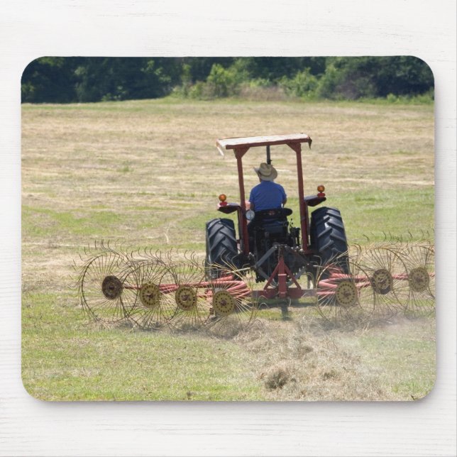 A young boy driving a tractor harvesting mouse pad (Front)
