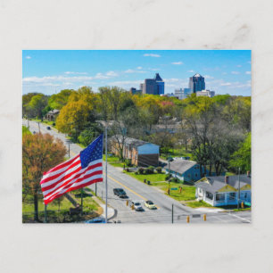 Above Greensboro, NC skyline with American Flag Holiday Postcard