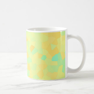 Abstract pattern of yellow and green shapes coffee mug