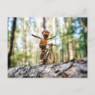 Acorn elf riding the bike without holding postcard