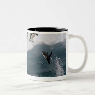 Adelie Penguins diving into sea Paulette Two-Tone Coffee Mug