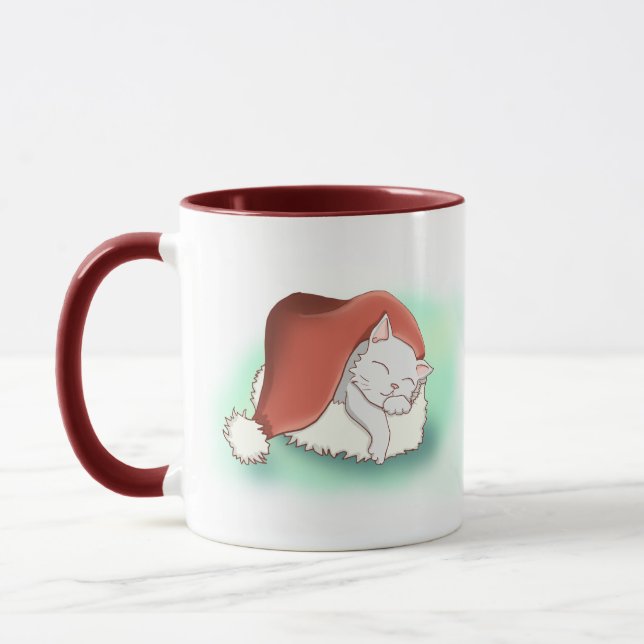 Adorable Christmas Cat Snoozing in Santa Hat Mug (Left)