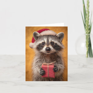 Adorable Raccoon in a Santa Hat Holding a Present Holiday Card